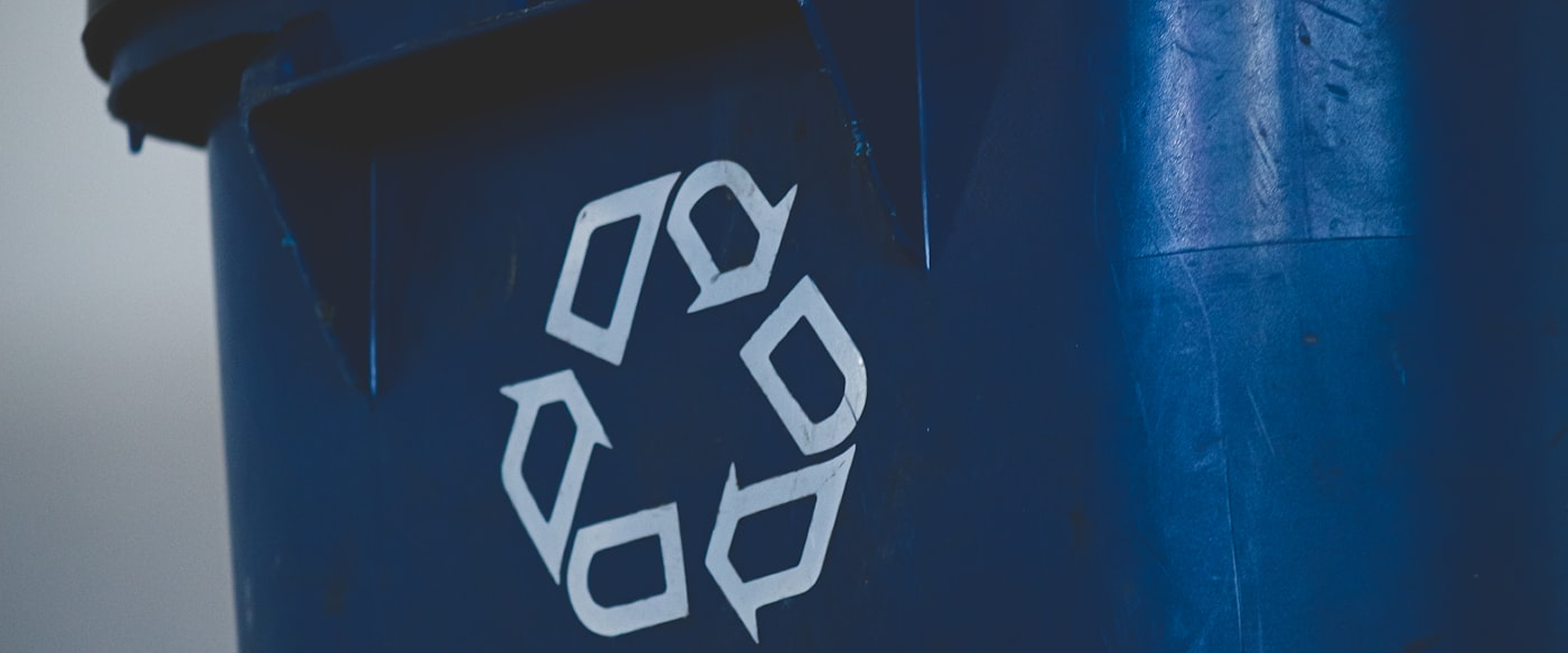 Recycling symbol on blue bin